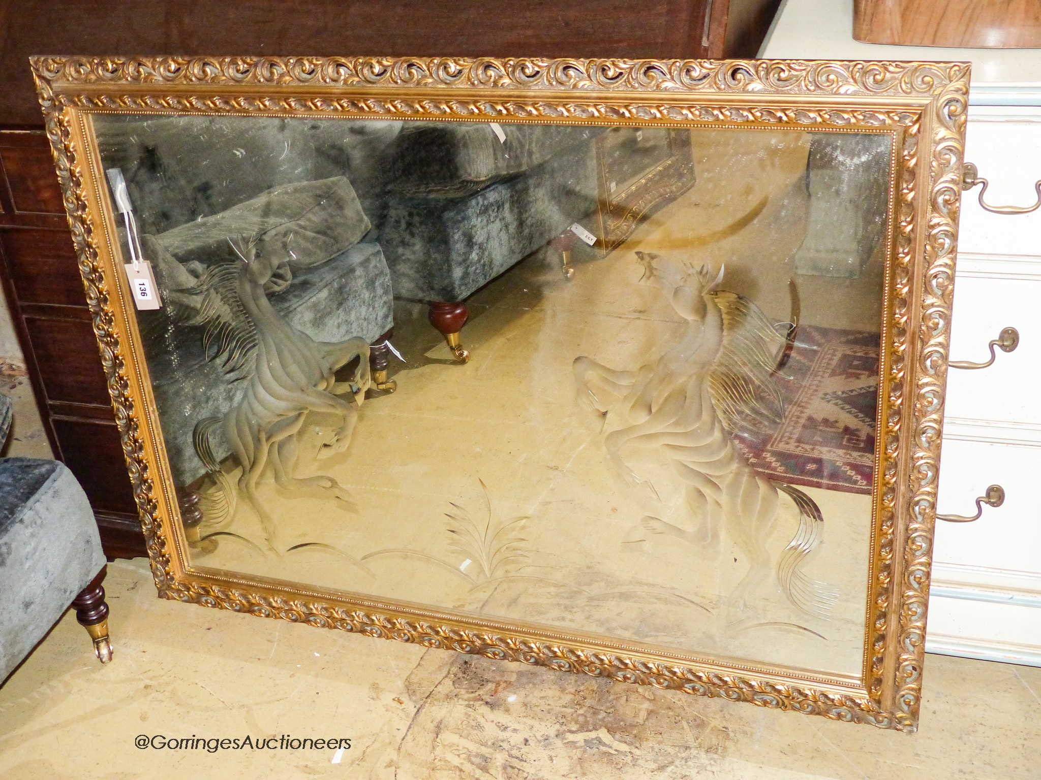 A rectangular gilt wall mirror etched with a stallion, width 120cm, height 90cm